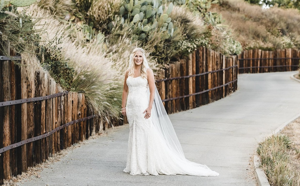Premium Photo  Bride with tailor choosing wedding dress in store